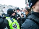 An Ottawa bylaw officer informs pro-Palestinian protest organizer Sarah Abdul-Karim that the group was being ticketed under the city noise bylaws.