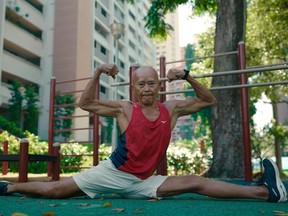 Older Singapore resident doing splits