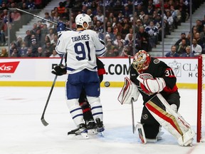 Anton Forsberg of the Ottawa Senators makes a save as John Tavares of the Toronto Maple Leafs looks on