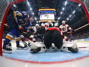 Josh Norris #9 , Claude Giroux #28 and Joonas Korpisalo #70 defend the goal against Jake Neighbours #63