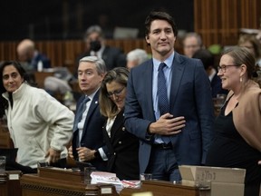 Prime Minister Justin Trudeau rises to vote during an overnight session in the House of Commons, Friday, December 8, 2023 in Ottawa.