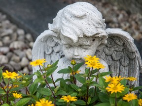 Angel and yellow flowers on a grave