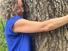 Woman hugging tree