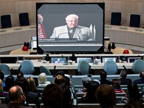 People watch a live broadcast from Ottawa of the Truth and Reconciliation Commission’s release of its final report on Indian Residential Schools, at the Edmonton city hall council chambers on June 2, 2015.
