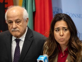Palestinian Ambassador to the United Nations, Riyad Mansour, left, listens as Permanent Representative of the United Arab Emirates to the United Nations, Lana Nusseibeh, speaks during a press conference at United Nations headquarters, Friday, Dec. 22, 2023.