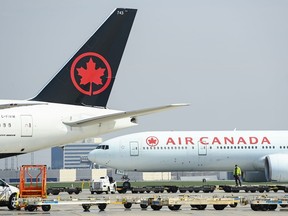 Air Canada planes sit on the tarmac at Pearson International Airport in Toronto