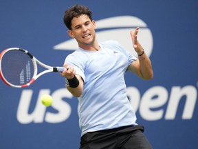 FILE: Dominic Thiem, of Austria, returns a shot to Ben Shelton, of the United States during the second round of the U.S. Open tennis championships on Aug. 30, 2023, in New York.