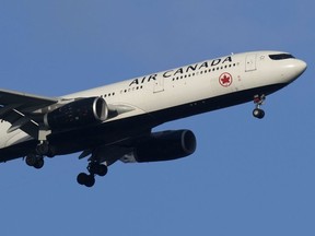 An Air Canada Airbus A330 approaches for landing in Lisbon, Saturday, Sept. 2, 2023.