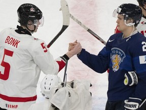 Canada's Oliver Bonk (5) shakes hands with Finland's Kasper Halttunen (22) following their game at the IIHF World Junior Hockey Championship in Gothenburg, Sweden, on Tuesday, Dec 26, 2023.