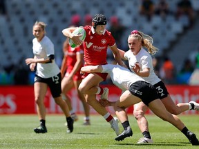 Canada captain Olivia Apps (with ball) charges through the New Zealand defence on Day 2 of the HSBC SVNS at Cape Town Stadium in a Sunday, Dec. 10, 2023, handout photo.
