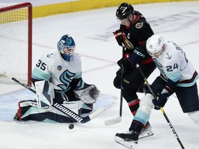 Seattle Kraken defenceman Jamie Oleksiak ties up Ottawa Senators left wing Brady Tkachuk