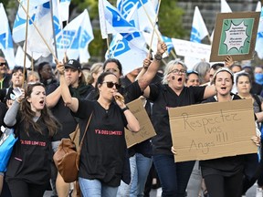 Union members of the Federation interprofessionnelle de la sante du Quebec (FIQ) march to the National Assembly to demonstrate, in Quebec City
