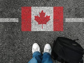 Man looks at Canadian flag