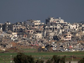 A picture taken from southern Israel on Jan. 24, 2024 shows destroyed buildings in the Gaza Strip, amid ongoing battles between Israel and the Palestinian militant group Hamas.