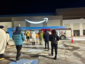 Amazon workers outside its London-area mega-plant amid -20 C temperatures following a fire alarm late on Sunday Jan. 14, 2024.