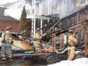 Ottawa Fire Services crew members battle a blaze on Sutcliffe Terrace in Barrhaven on Friday afternoon.
