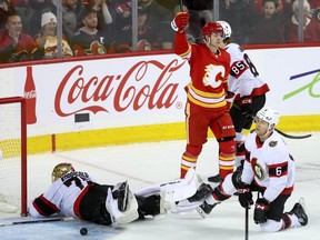 Calgary Flames Yegor Sharangovich scores on Ottawa Senators goalie Joonas Korpisalo