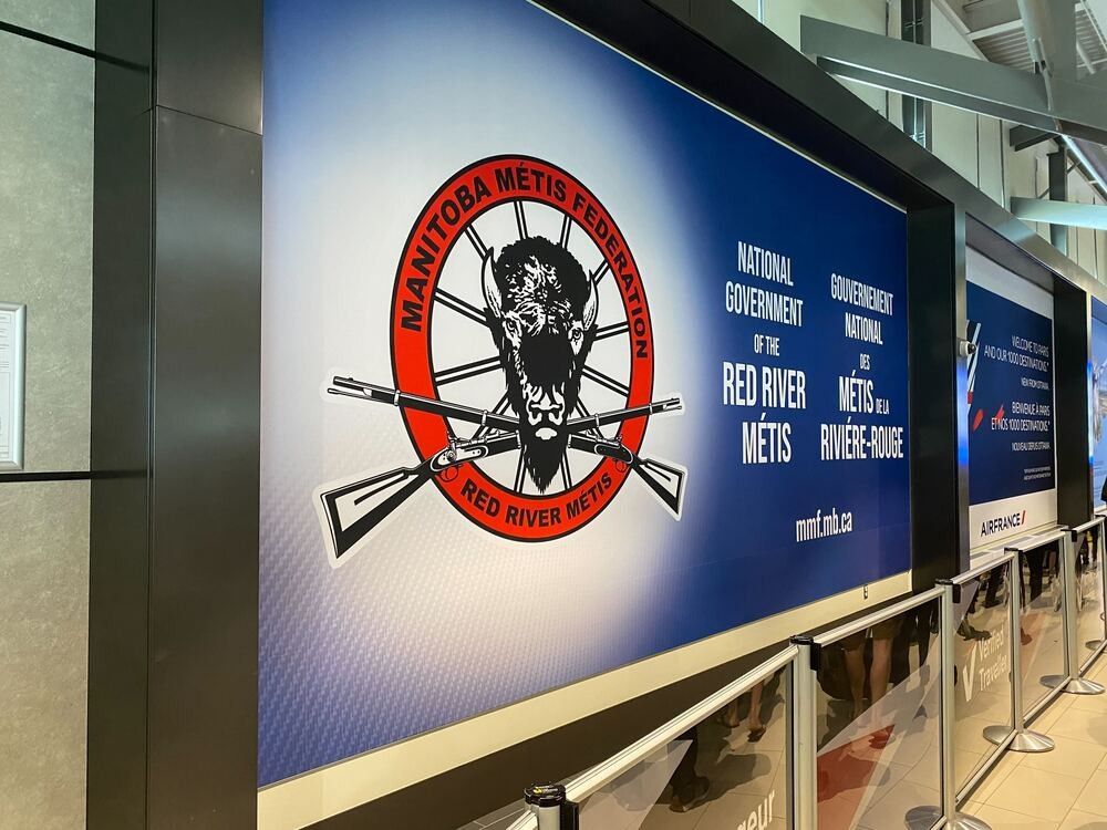 An August 2023 file photo shows Manitoba Metis Federation signage in the Ottawa International Airport before it was removed by the airport authority.