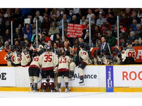 Montreal coaching staff talk to their players before overtime Tuesday. TONY CALDWELL, Postmedia.