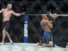 Justin Gaethje looks on as the referee checks on Donald (Cowboy) Cerrone after stopping the fight during their lightweight match atv UFC Fight Night at Rogers Arena in Vancouver, Saturday, September, 14, 2019.