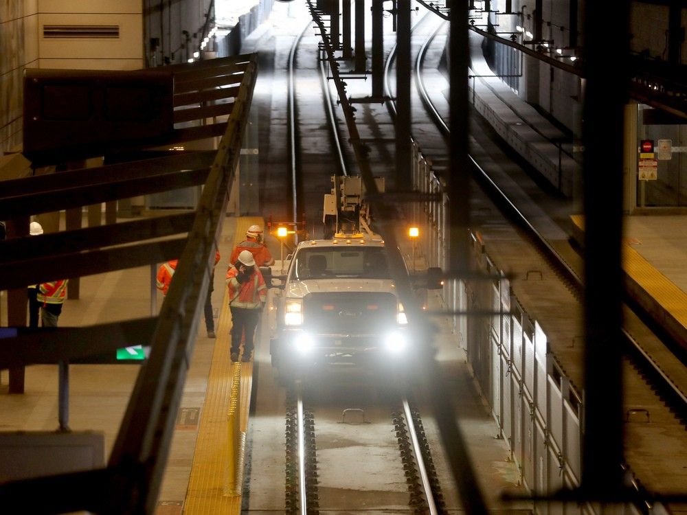 Work crews inspect St. Laurent Station Tuesday morning. Train service was suspended between Blair and Hurdman Station while the inspection was done 