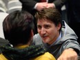Prime Minister Justin Trudeau speaks with a member of the public at an event following the signing of the Nunavut devolution agreement in Iqaluit on Thursday, January 18, 2024.