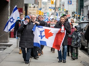 A group from the Jewish community gathered on Parliament Hill and marched to the Embassy of Qatar on Metcalfe Street, Sunday, Feb. 4, 2024.