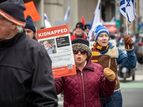 A group from the Jewish community gathered on Parliament Hill and marched to the Embassy of Qatar on Metcalfe Street, Sunday, Feb. 4, 2024.