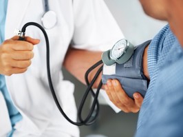 Doctor taking blood pressure for patient