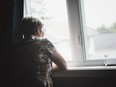 Older woman looking out window