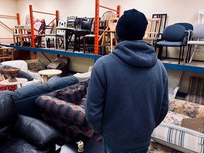A man looks over the choices at the Matthew House Ottawa Furniture Bank