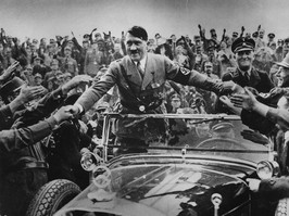 Adolf Hitler shaking hands with supporters from a car