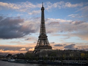FILE: This photograph taken on December 5, 2023, shows a general view of the Eiffel tower along the Seine River in Paris.