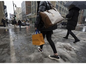 Shoppers walk through slush during a winter storm in Montreal, Quebec, Canada, on Friday, Dec. 23, 2022. The consumer price index rose 6.8% from a year ago, higher than economist expectations of 6.7% and down from 6.9% in October, Statistics Canada reported Wednesday in Ottawa.
