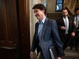 Prime Minister Justin Trudeau walks past journalists as he makes his way to caucus, February 28, 2024.