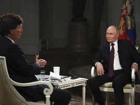 Russian President Vladimir Putin, right, attends an interview with former Fox News host Tucker Carlson at the Kremlin in Moscow, Russia on Feb. 6, 2024.