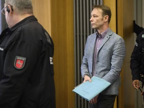 FILE - Christian B. centre, arrives at the start of his trial, at Braunschweig district court, in Brunswick, Germany, on Feb. 16, 2024. A man who is also under investigation in the disappearance of British toddler Madeleine McCann won't respond to unrelated charges of sexual offenses at a trial that opened last week in Germany, his lawyer said Friday, Feb. 23, 2024.