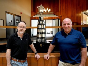 Bob Jordan, left, and Steve Lodge pose by the Quebec Challenge Cup proudly displayed at the Brockville Country Club on Tuesday, Feb. 27, 2024 in Brockville, Ont. (RONALD ZAJAC/The Recorder and Times)