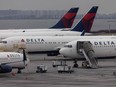 Delta Airlines passenger aircrafts are seen on the tarmac of John F. Kennedy International Airpot in New York,on December 24, 2021