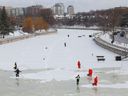 NCC crews flood the ice near the Flora Footbridge on the Rideau Canal in Ottawa Friday.