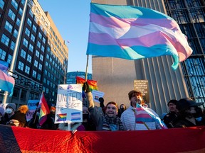 Pro-LGBTQ2+ protesters are seen during a rally outside of an event Alberta Premier Danielle Smith attended in Ottawa on Monday, Feb. 5, 2024.