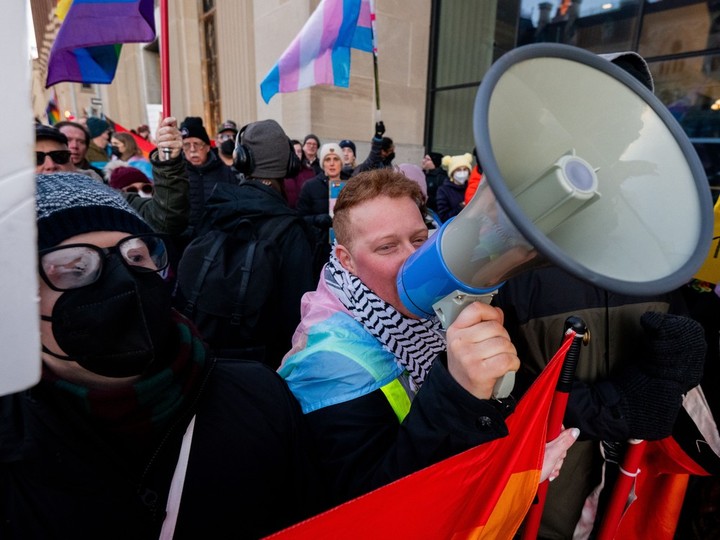  A pro-LGBTQ2+ protester uses a megaphone to lead a chant during a rally outside of an event Alberta Premier Danielle Smith attended in Ottawa on Monday.