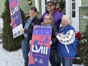 Don Crisman, far left, poses with his wife, Beverley, far right, his daughter Sue Metevier, and her partner Charles Hugo, with posters of Super Bowl 58 tickets, Thursday Jan. 18, 2024, in Kennebunk, Maine. Don Crisman is one of the very few people who has attended every Super Bowl.