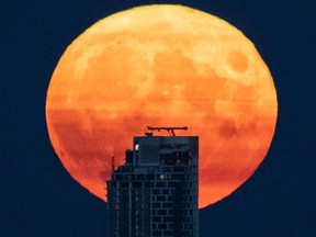A full moon rises above Vancouver in 2021. The moon is smaller now, having lost an estimated 50 metres or so over several million years.