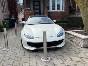 Bollards in a private driveway protect a sports car from theft