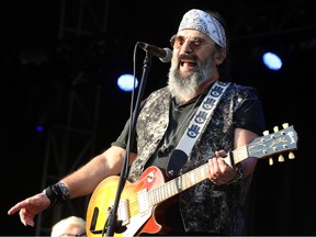 Steve Earle on stage with his guitar