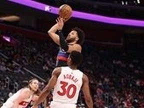 Cade Cunningham of the Detroit Pistons takes a first half shot behind Ochai Agbaji #30 of the Toronto Raptors at Little Caesars Arena.