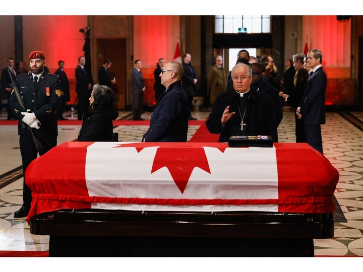  A priest pays his respects to former Canadian Prime Minister Brian Mulroney at the Sir John A. Macdonald Building where Mulroney will lie-in-state in Ottawa, Canada, on March 19, 2024.