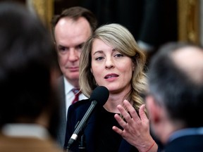 Foreign Affairs Mélanie Joly, with government House leader Steven MacKinnon behind her, speaks to reporters in the Foyer of the House of Commons in Ottawa on Monday, March 18, 2024.
