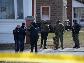 Police surround a home in Smiths Falls on Thursday, Mar. 21, 2024 while searching for a wanted man. He was later arrested in a different home across town.
